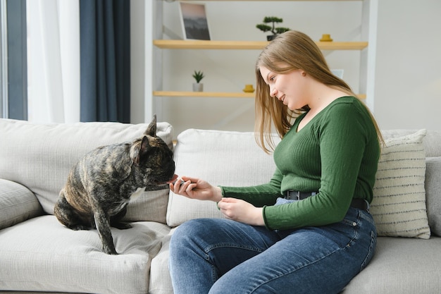 Young woman with her dog at home Lovely pet