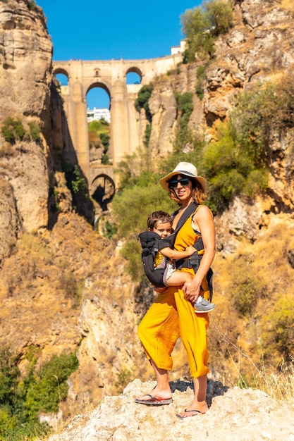 A young woman with her son at the new bridge viewpoint in Ronda province of Malaga Andalucia