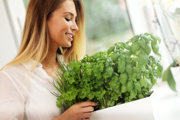 young woman with herbs in the kitchen