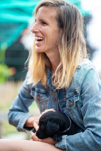 Young woman with labrador puppy