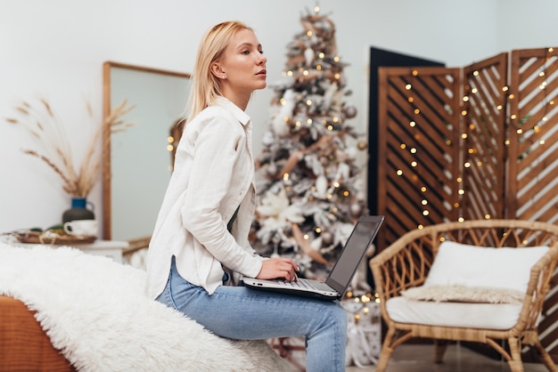 Young woman with laptop at Christmas time