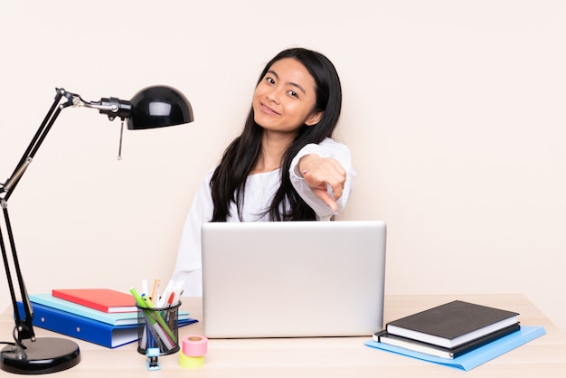 Young woman with a laptop sitting at a table