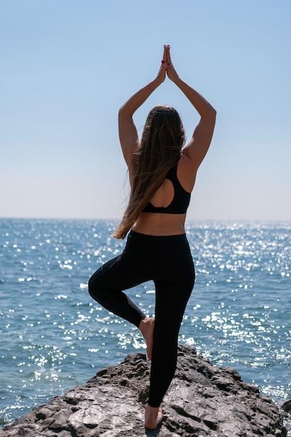 Young woman with long hair fitness instructor in sportswear leggings and tops stretching before