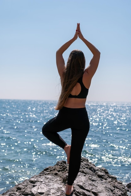 Young woman with long hair fitness instructor in sportswear leggings and tops stretching before