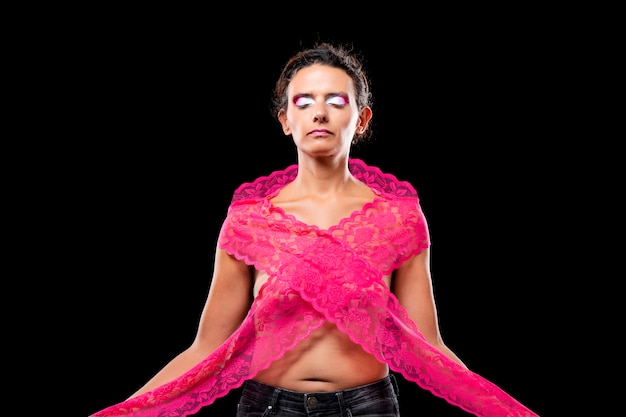 Young woman with long pink fabric, depicting the symbol and fight against breast cancer awareness.