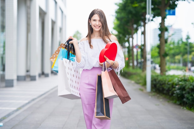 Young woman with many shopping bags