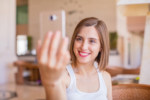 young woman with obile phone in a resort