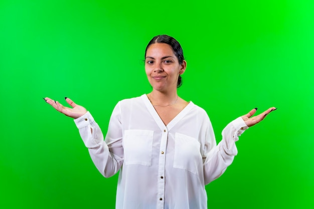 Young woman with open arms green background