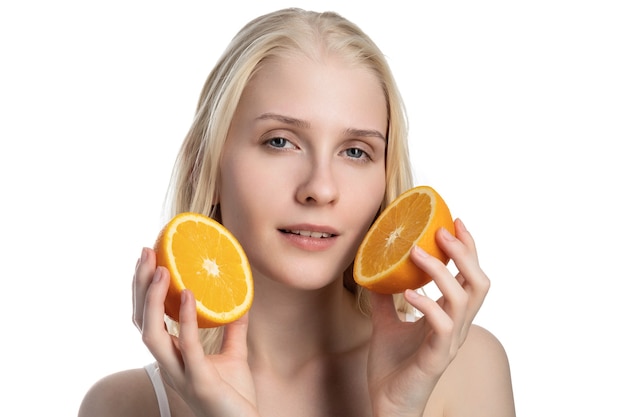 Young woman with oranges in her hands.