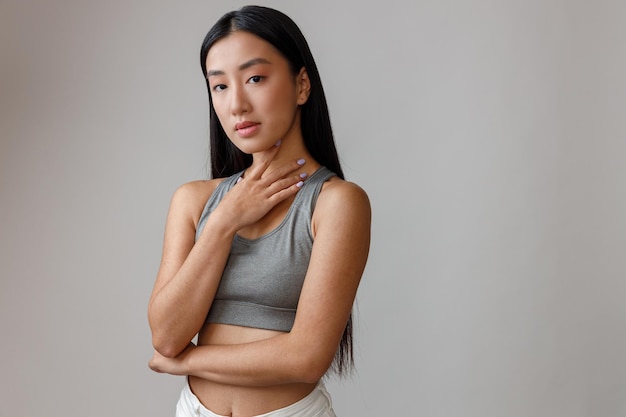 Young woman with perfect skin standing in studio