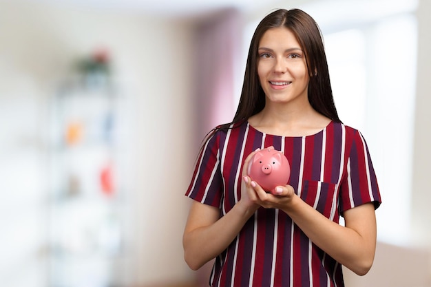 Young woman with piggy bank