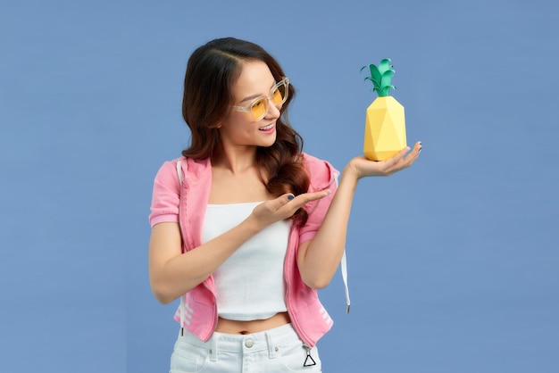 Young woman with pineapple isolated