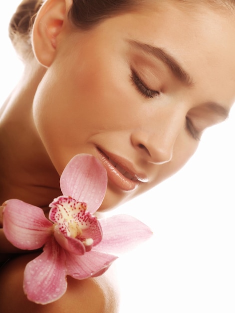 Young woman with pink orchid