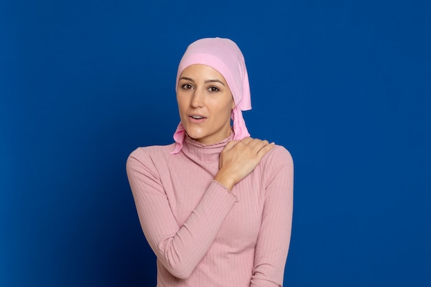 Young woman with pink scarf on the head on a blue