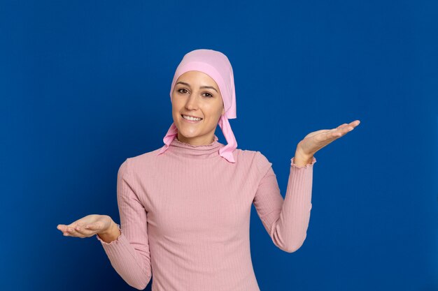 Young woman with pink scarf on the head on a blue