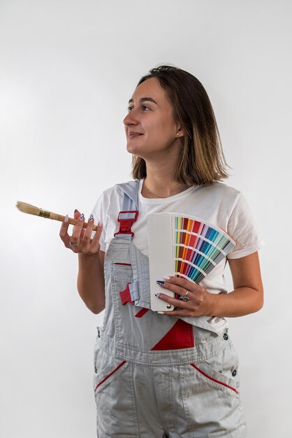 Young woman with repair tools in special clothes isolated on white background construction house repair