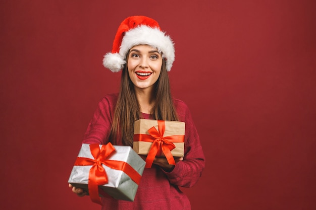 Young woman with Santa hat holding present box