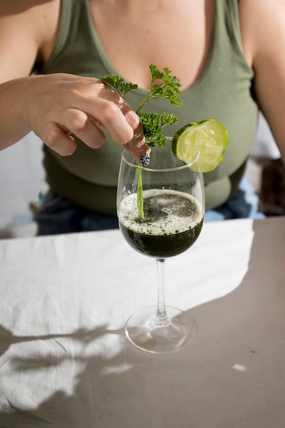 Young woman with a set of green ingredients lettuce spinach for a healthy diet