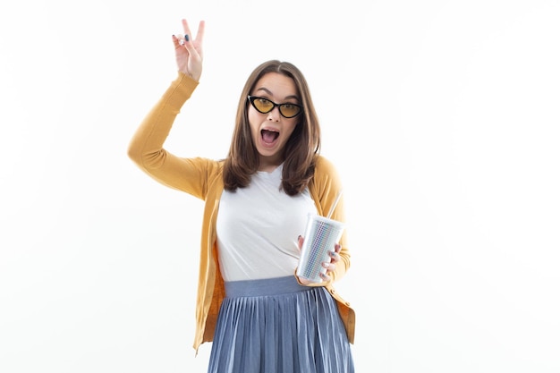 A young woman with a shiny glass of lemonade on a white background Cool mood summer drinks