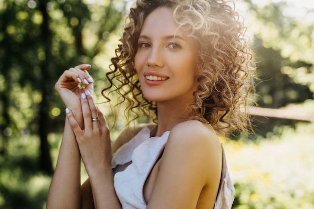 Young woman with short curly hair smiling