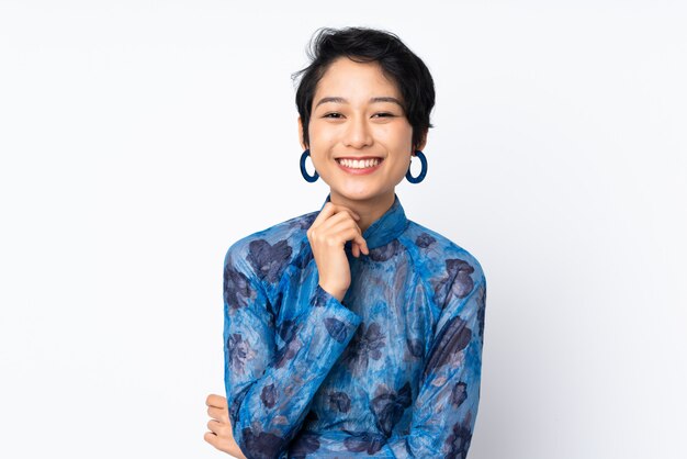 Young woman with short hair wearing a traditional dress over white