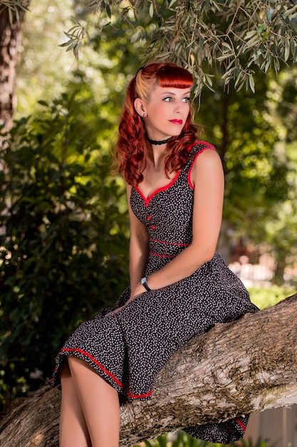 Young woman with a simple spring dress posing on the park