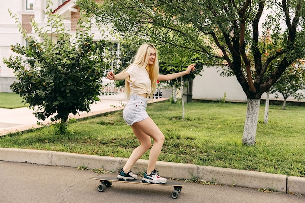 Young woman with skateboard outdoors