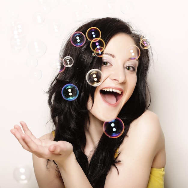 Young woman with soap bubbles