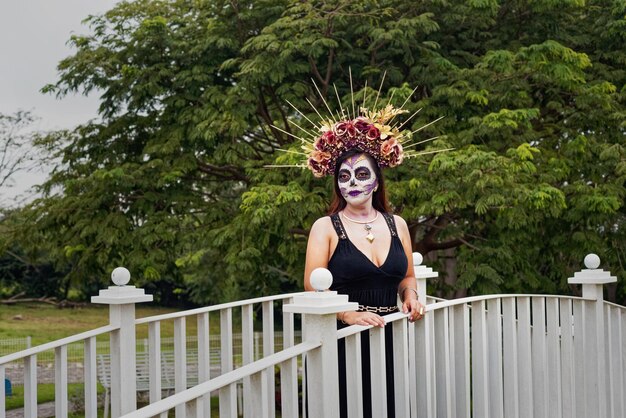 Young woman with sugar skull makeup Day of The Dead Catrina portrait