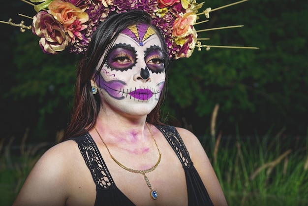 Young woman with sugar skull makeup Day of The Dead Catrina portrait