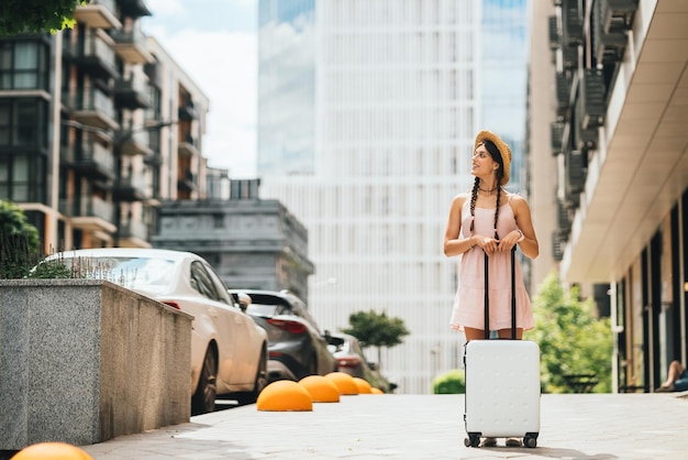 Young woman with suitcase and looks to the side