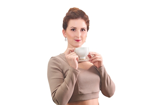 Young woman with a tea cup in her hands on a white background