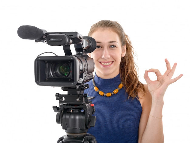 Young woman with a video camera, ready for filming on white background