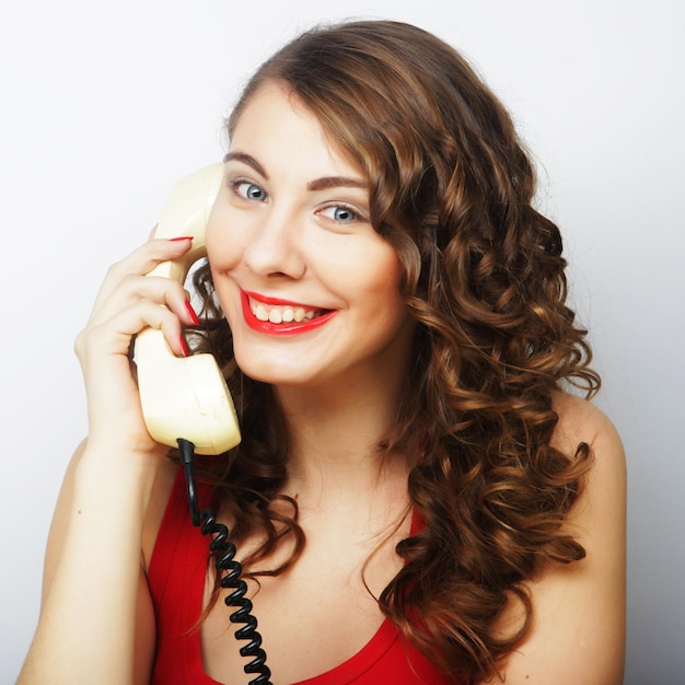 Young woman with vintage phone