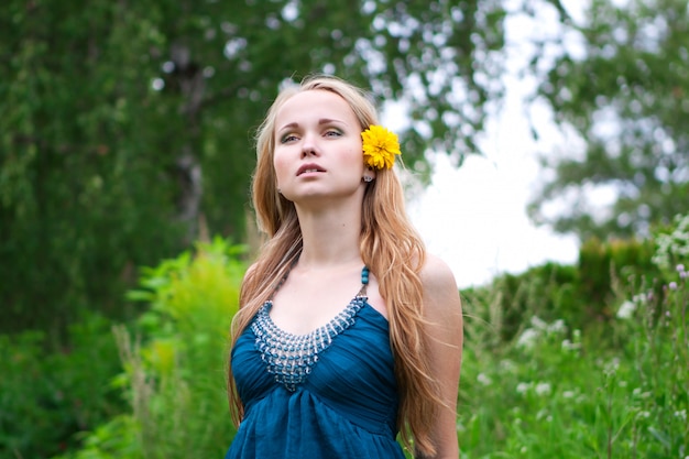  young woman with a yellow flower in her hair 