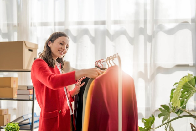 young woman work for checking the clothes in the home concept e commerce