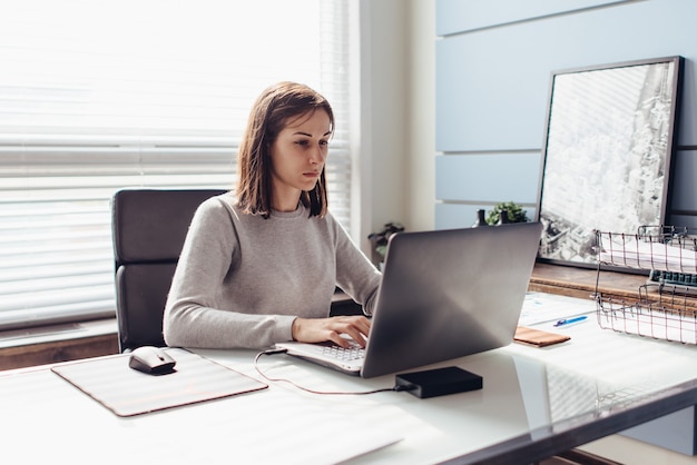 Young woman at work at her workplace