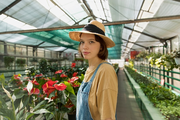 Young woman working in a greenhouse