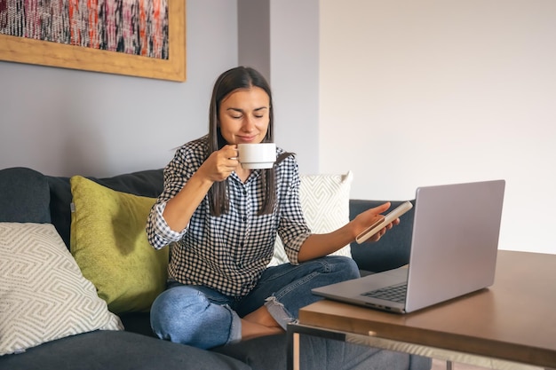 A young woman working on a laptop at home