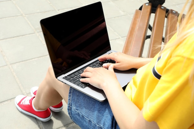 Young woman working on laptop outdoor concept of freelancer