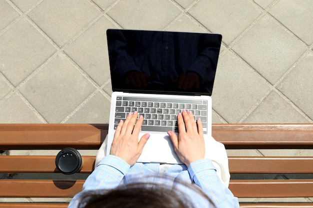 Young woman working on laptop outdoor concept of freelancer