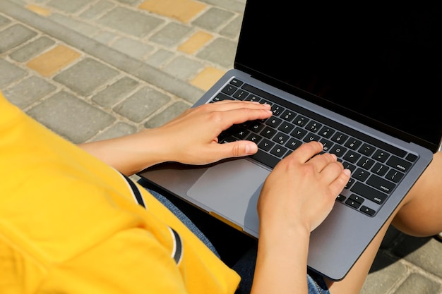 Young woman working on laptop outdoor concept of freelancer