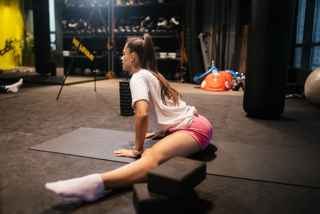 Young woman working out doing yoga or pilates exercise