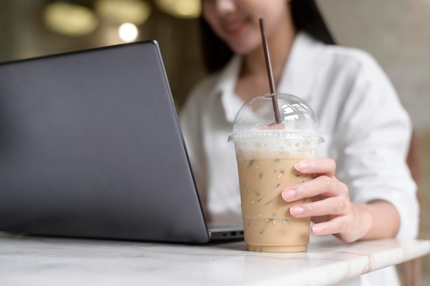 A young woman working with laptop computer in cafe