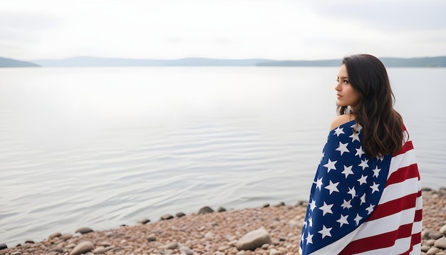 A young woman wrapped in an American flagpatterned blanke