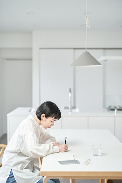 Young woman writing in notebook