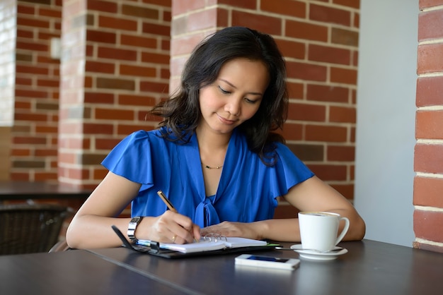 Young woman writing