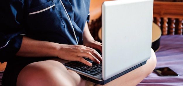 Young woman xAWorkingyoung woman Working sitting on the couch with using a laptop to type