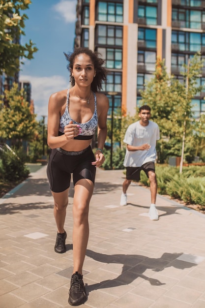 Young woman and young man having a running competition