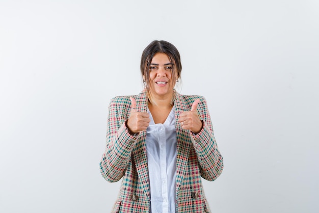 Young womans showing a good hand sign on white background